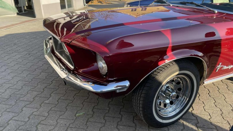 Frontpartie des roten Ford Mustang mit Motorhaube, Scheinwerfer und Chromstoßstange